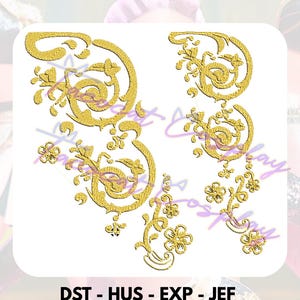 May include: Gold embroidery design featuring floral and scrollwork patterns. The design includes the text "DST - HUS - EXP - JEF" and "PES - VIP - VP3 - XXX" at the bottom. The design is on a white background.