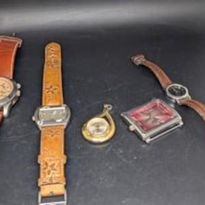 May include: Five watches with leather bands and various face designs. The watches include a round silver watch with a brown leather band, a rectangular watch with a floral embossed leather band, a gold pendant watch, and a square watch with a red face.