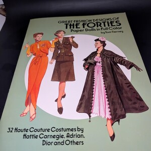 May include: A softcover book titled Great Fashion Designs of the Forties Paper Dolls in full Color by Tom Tierney. The cover features illustrations of three figures in vintage clothing, including an orange dress, a brown suit, and a black coat.