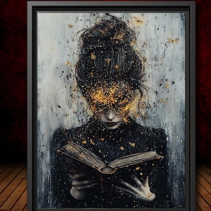 May include: A framed wall art print depicting a person with a dark bun hairstyle reading an open book. The figure is surrounded by shimmering gold particles and small butterfly silhouettes against a textured gray and black background.
