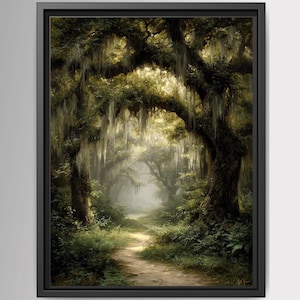 May include: A framed wall art print depicting a dirt path winding through a dense forest of large trees draped in hanging Spanish moss. The scene features deep green foliage, dark tree trunks, and soft light filtering through the canopy.