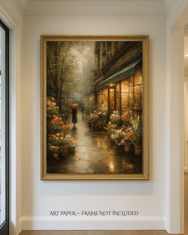 May include: A vertical wall art print featuring a rainy city street scene with a person holding a red umbrella, surrounded by flower stalls and warm glowing shop windows. The print includes the text ART PAPER &ndash; FRAME NOT INCLUDED.