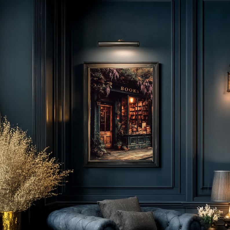 May include: A framed rectangular wall art print depicting a bookstore storefront at night with the word BOOKS displayed above the entrance. The scene features warm interior lighting, dark wood architecture, and purple floral accents.