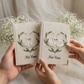 Lily of the Valley Wedding Vow Books, Embroidered Swan Heart Vow Journals, White Floral Wedding Stationery, His and Her Vows Notebooks product logo