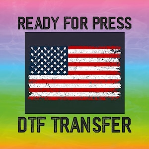 May include: Ready for Press DTF Transfer with a distressed American flag design. The design is printed on a dark grey background.