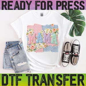 May include: White t-shirt with the word "MAMA" in pastel colors, floral and gingham patchwork design. The shirt is paired with denim shorts and black sneakers. The text "READY FOR PRESS" and "DTF TRANSFER" are at the top and bottom.