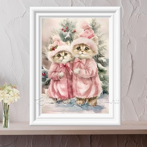 May include: Watercolor painting of two kittens wearing pink coats and hats, standing in front of a Christmas tree. The kittens have bows and holly berries on their hats. The artwork is framed in a white border.