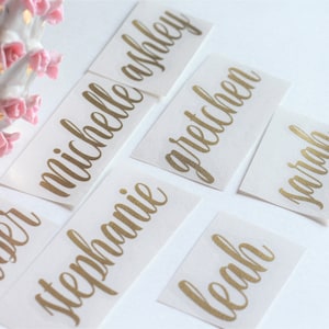May include: Gold foil name stickers with the names Amber, Michelle, Stephanie, Gretchen, Sarah, and Leah.
