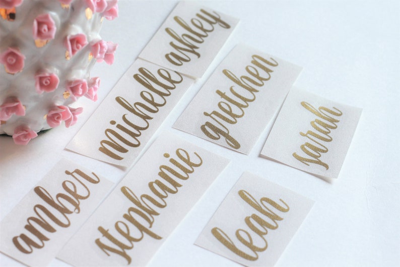 May include: Gold foil name stickers with the names Amber, Michelle, Stephanie, Gretchen, Sarah, and Leah.