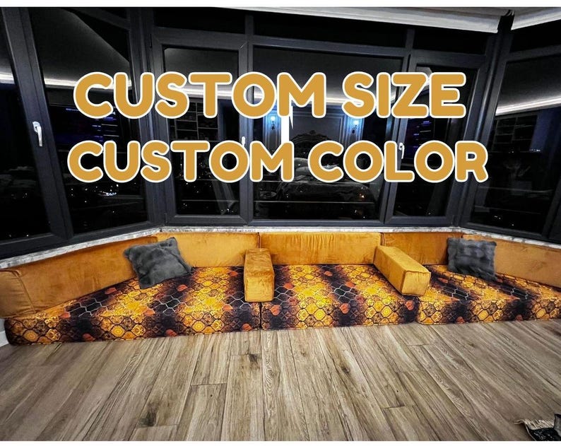 May include: A floor seating arrangement featuring mustard yellow velvet back cushions and a patterned seat base with orange, black, and gold geometric motifs. The text CUSTOM SIZE CUSTOM COLOR is overlaid in bold yellow letters against the dark window background.