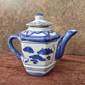 May include: A set of three ceramic mugs with a speckled, matte finish. The mugs are in shades of cream, light gray, and dark gray. Each mug has a simple, minimalist design and a rounded handle. The mugs are likely for coffee or tea.