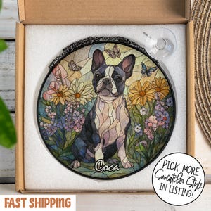 May include: Round stained glass suncatcher featuring a Boston Terrier dog in a garden setting with flowers and butterflies. The dog is black and white, with the name "Coca" at the bottom. Includes a hanging chain and suction cup.