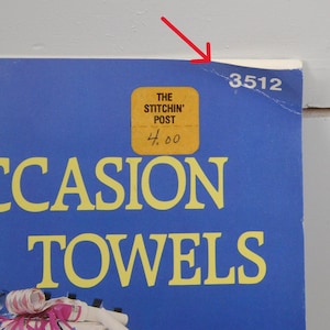 May include: A blue background with the words "OCCASION TOWELS" in yellow. A yellow sticker reads "THE STITCHIN' POST" and "4.00". The number "3512" is printed in the upper right corner.