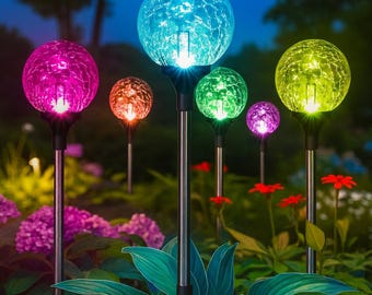 May include: A collection of colorful, illuminated garden stake lights. Each light features a crackled glass globe in shades of pink, orange, blue, green, purple, and yellow. The lights are set in a garden with flowers and foliage.