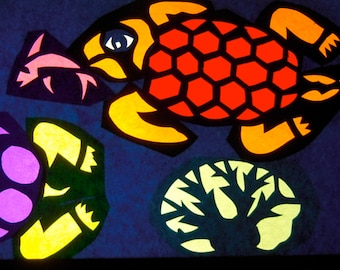 May include: A colorful illustration of sea life on a dark blue background. The illustration features three turtles, one fish, and a coral reef. The turtles are green, orange, and purple. The fish is blue and the coral reef is yellow.
