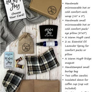 May include: A gift box labeled "Box #3 Deluxe!" contains a variety of items, including a brown neck wrap, a plaid eye pillow, a mug cozy, a small burlap bag, two coffee candies, a sleeve for a coffee cup, a card, a bottle of essential oil, and a fridge magnet. The box is hand-stamped with the words "Warm Hug".