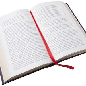 May include: An open book with a red ribbon bookmark. The book has a black cover and white pages. The text on the pages is in black.