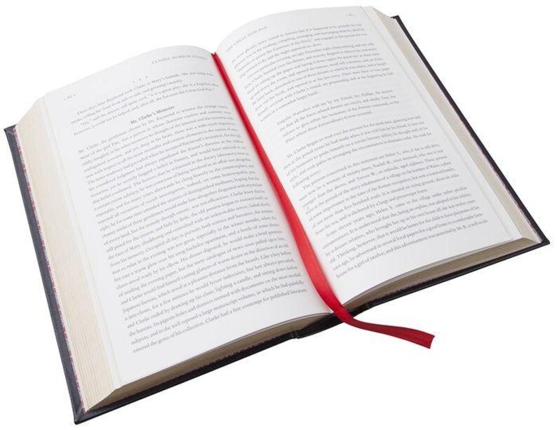 May include: An open book with a red ribbon bookmark. The book has a black cover and white pages. The text on the pages is in black.