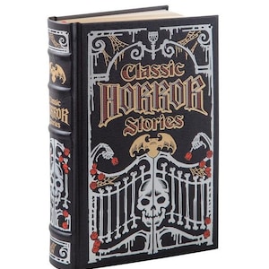 May include: A black book with a silver and gold design. The title is "Classic Horror Stories" with a skull and bat design.