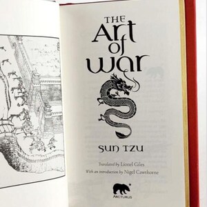 May include: The Art of War by Sun Tzu, a book with a black and white illustration of a dragon on the cover. The book is published by Arcturus.