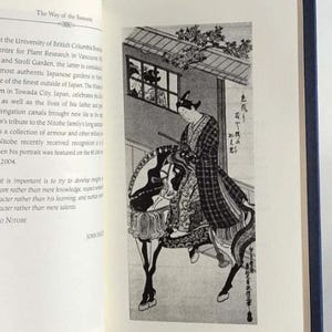 May include: A black and white illustration of a person riding a horse. The person is wearing a patterned robe and a hat. The illustration is set against a background of a building with a window and a tree.