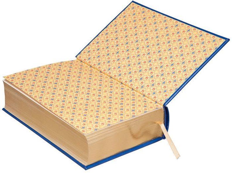 May include: A closed book with a blue cover and gold-gilded edges. The pages are decorated with a repeating pattern of red and blue flowers.