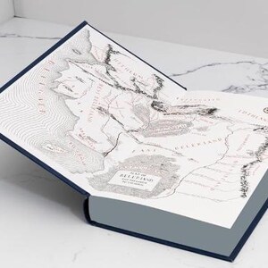 May include: A blue hardcover book with a map of Beleriand and the lands of the First Age. The map is printed in black and white with red text.