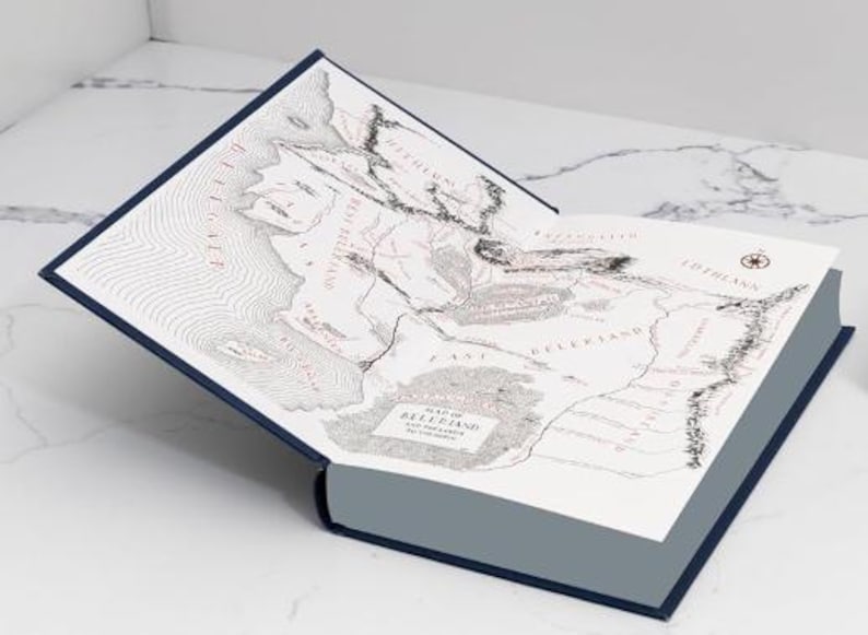 May include: A blue hardcover book with a map of Beleriand and the lands of the First Age. The map is printed in black and white with red text.