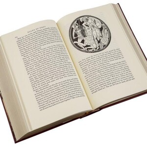 May include: An open book with a black and white illustration of a scene from Greek mythology. The book is titled "Tales of Troy" and the text describes the battle between the Greeks and Trojans.