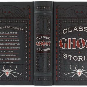 May include: A black hardcover book with a red and white title "Classic Ghost Stories". The cover features a spider with a red skull and crossbones on its back. The spine of the book lists the authors of the stories, including Edgar Allan Poe, Charles Dickens, and J. Sheridan Le Fanu.