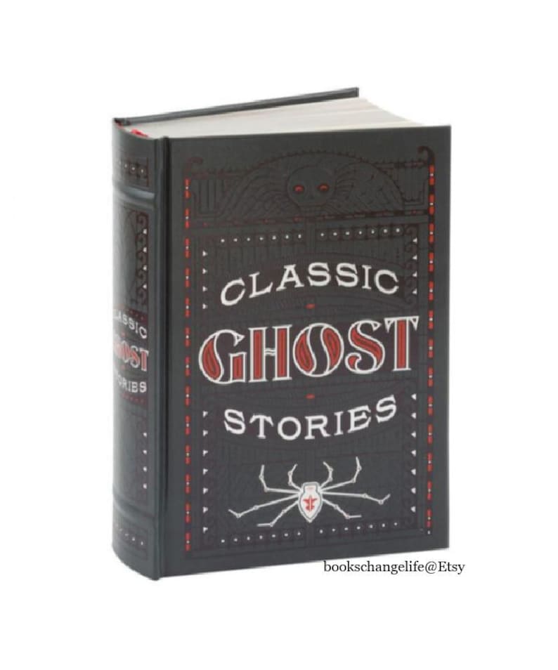 May include: A black hardcover book with the title "Classic Ghost Stories" in red and white lettering. A red spider with a white body is on the front cover.