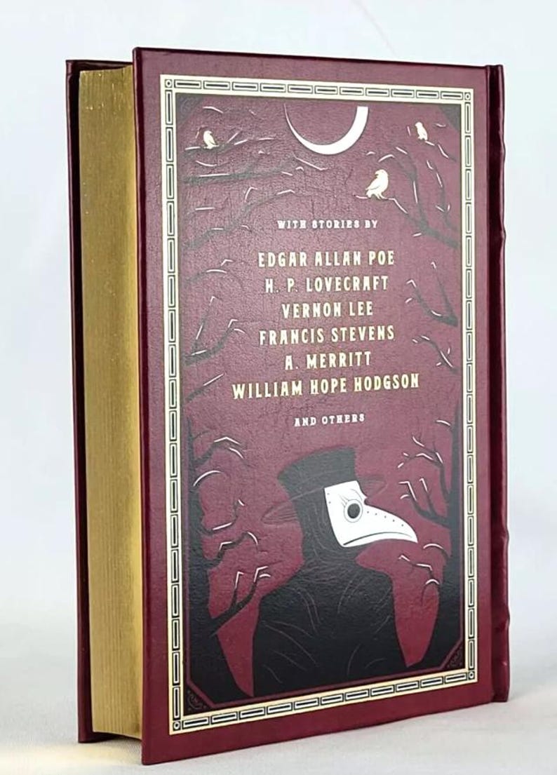 May include: A burgundy hardback book with a gold spine. The cover features a black and white illustration of a person wearing a plague doctor mask in a dark forest setting. The text on the cover reads "WITH STORIES BY EDGAR ALLAN POE H.P. LOVECRAFT VERNON LEE FRANCIS STEVENS A. MERRITT WILLIAM HOPE HODGSON AND OTHERS".