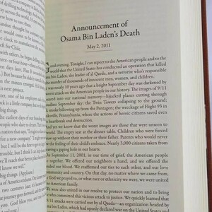 May include: A black and white book page with the text "Announcement of Osama Bin Laden's Death" and the date "May 2, 2011". The text below the title describes the death of Osama Bin Laden and the events of 9/11.