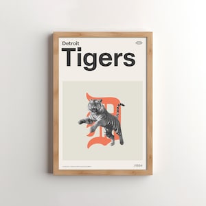 May include: A framed print with a white background and the text "Detroit Tigers" in black. The print features a stylized orange "D" with a black and white tiger jumping in front of it. The print is numbered "1/1894".