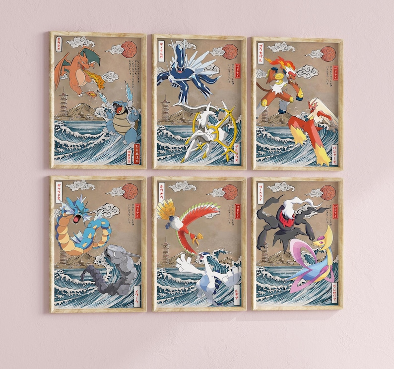 May include: Six framed prints featuring Pokemon characters in a Japanese art style. The prints are on a light pink wall. Each print features a different Pokemon character, including a red and orange dragon, a blue and white bird, a red and yellow fire creature, a blue and green water creature, a red and yellow bird, and a black and white ghost creature.