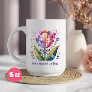 May include: White ceramic mug featuring a colorful tulip design with patchwork patterns and the text "God is good all the time." The mug is 15 oz and has a large handle.