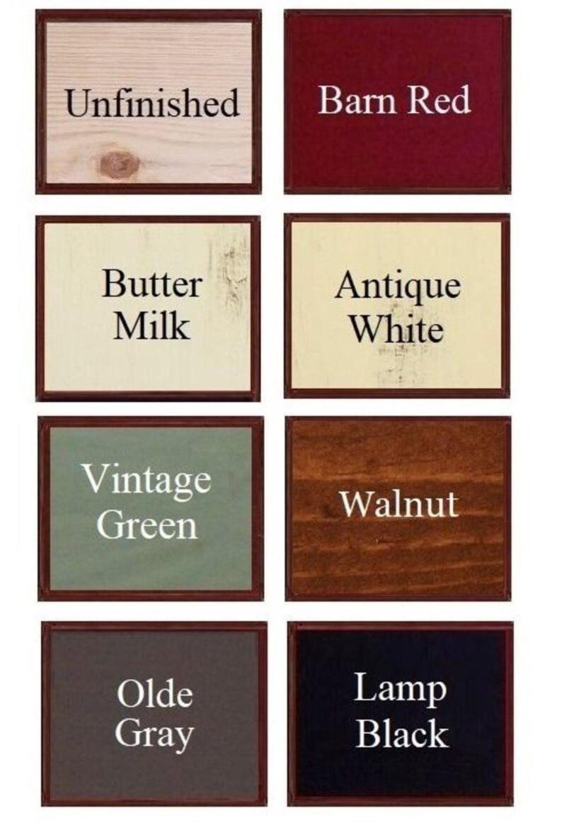 May include: A grid of eight rectangular wood colour samples with black text labels. The colours are Unfinished, Barn Red, Butter Milk, Antique White, Vintage Green, Walnut, Olde Gray, and Lamp Black. Each sample is framed in a thin dark brown border.