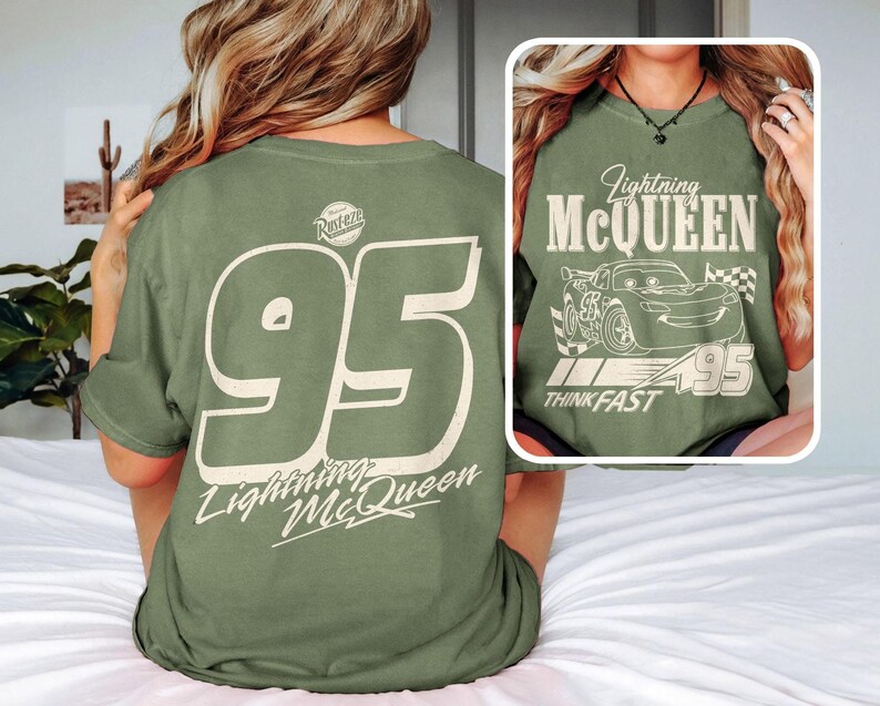May include: Olive green t-shirt featuring the number 95 and the text "Lightning McQueen" on the back. The front of the shirt displays a graphic of Lightning McQueen with the text "Lightning McQueen, Think Fast, 95".
