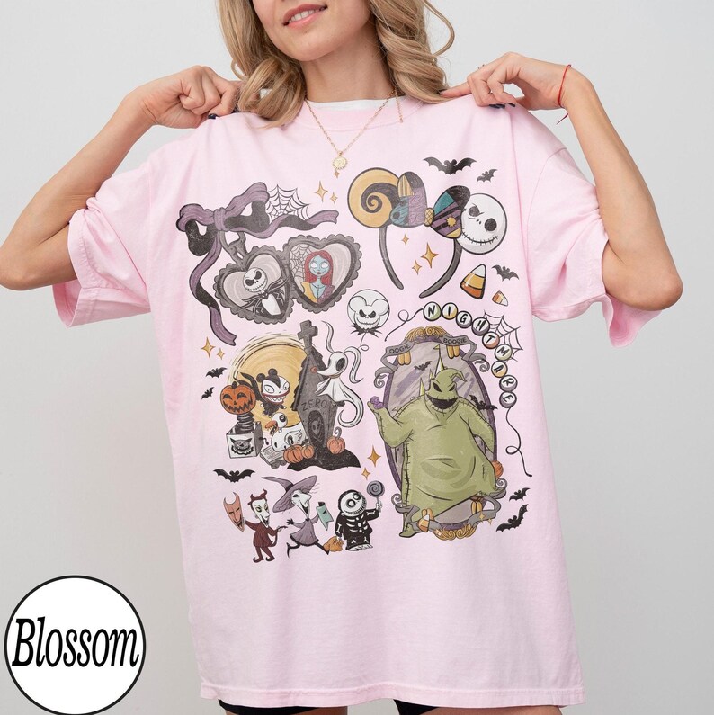 Może przedstawiać: Jasnor&oacute;żowy t-shirt z nadrukiem graficznym przedstawiającym postacie i ikony z Miasteczka Halloween. Wz&oacute;r zawiera Jacka Skellingtona, Sally, Oogie Boogie, Zero oraz Locka, Shocka i Barrel, a także nietoperze i napisy.