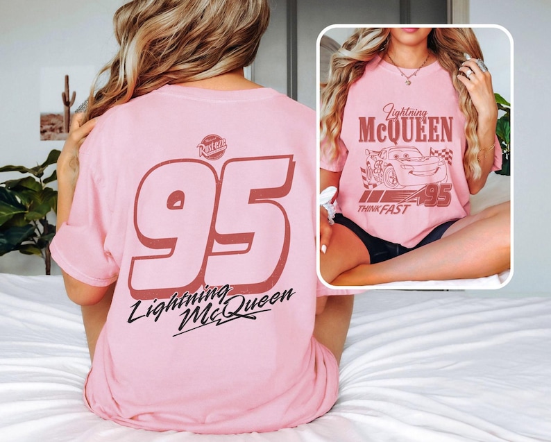May include: Pink t-shirt featuring Lightning McQueen graphics. The front displays a graphic of the character and the text "Lightning McQueen" and "Think Fast". The back has a large "95" and the text "Lightning McQueen".