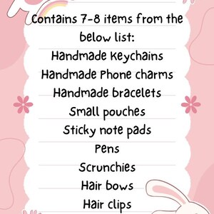 May include: Pink and white illustrated card with a cat and a rabbit. The card lists 7-8 handmade items including keychains, phone charms, bracelets, pouches, sticky note pads, pens, scrunchies, hair bows, hair clips, and free stickers.
