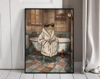 May include: A framed wall art print depicting a green frog wearing brown sunglasses and a white bathrobe, standing in a bathroom with a clawfoot bathtub, tiled floor, and a window. The scene features muted tones and a vintage-inspired aesthetic.