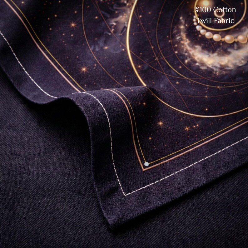 May include: A close-up of a dark navy blue fabric with a celestial design. The fabric features gold lines, stars, and a swirling galaxy pattern. The text "%100 Cotton Twill Fabric" is visible in the upper right corner.