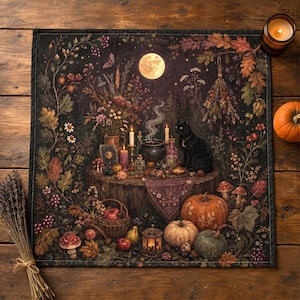 May include: A square fabric altar cloth featuring a dark forest scene with a full moon, a black cat, a steaming cauldron, candles, and various pumpkins. The illustration includes autumn foliage, berries, mushrooms, and a basket of fruit.