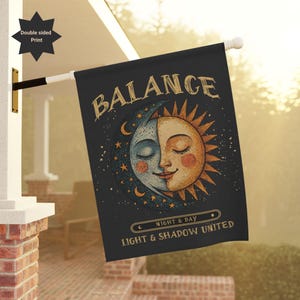 May include: A double-sided print flag with a celestial design. The flag features a split face of the sun and moon, with the word "BALANCE" at the top. The text "NIGHT & DAY" and "LIGHT & SHADOW UNITED" are also included.