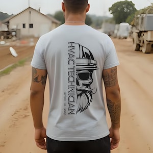 May include: Light gray t-shirt featuring a black graphic of a skull wearing a hard hat and sunglasses, with a long beard. The text "HVAC TECHNICIAN" is printed vertically on the left side, with "SUPPORT THE TRADES" below.