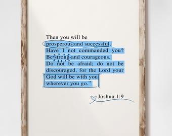May include: A framed print with a white background and brown frame. The print features a blue and white text overlay with the quote "Then you will be prosperous and successful. Have I not commanded you? Be strong and courageous. Do not be afraid; do not be discouraged, for the Lord your God will be with you wherever you go." Joshua 1:9. The print also includes the text "Gaia Art Prints Curated Wall Art".