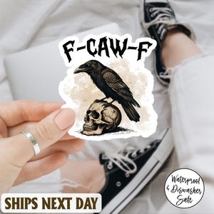 May include: A sticker with a black crow on a human skull, with the text "F-CAW-F". The design has a vintage, distressed look. The sticker is waterproof and dishwasher safe.