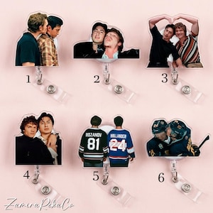 May include: A collection of six clear acrylic badge reels featuring images of people. The badge reels have a clear plastic strap and a metal clip. The images include two people embracing, and two people wearing hockey jerseys.