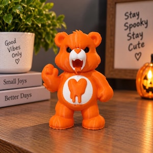 May include: An orange bear figurine with a white face and a white belly patch featuring an orange melting heart. The bear has an open mouth with visible teeth, a raised fist, and a textured surface consistent with 3D printed plastic construction.
